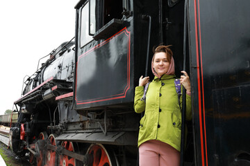 Woman on step of steam locomotive