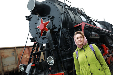 Woman on background of steam locomotive