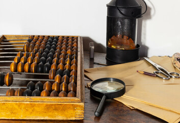 the post office of the last century, paper envelopes, scissors and a magnifying magnifier in the foreground, abacus on the left