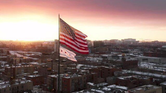 SLOW MOTION American Flag blowing in wind on pink sunset sky background. USA American Flag on winter day. Waving United states of America famous flag in front of golden sky. Independence Day, America