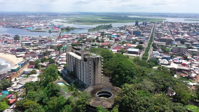 Aerial abandoned resort hotel Monrovia Liberia circle part 1. West Africa suffers extreme poverty and hunger. Civil war, EBOLA and COVID destruction. Crowded homes and businesses.