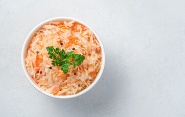 Sauerkraut with parsley on a gray background. Top view, copy space.