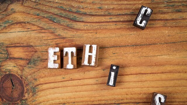 ETHICS concept. Text on a wooden background