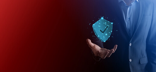 Businessman hold low poly polygon shield with a tick icon.Secure Access System Concept.Business...