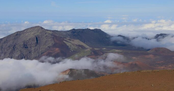 left to right panning motion of the cloud cover near the top of the volcano summit crater at Haleakala National Park which is a massive shield volcano standing at 10,023 feet, Maui, Hawaii, USA