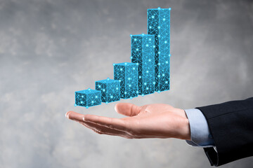Business man holding 3D graphs low polygonal and stock market statistics gain profits. Concept of growth planning,business strategy.economic growing concept.Business strategy. Digital marketing.
