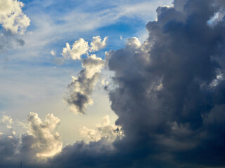 Dark and white clouds on a background of blue sky