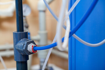 Blue plastic tube on water purification system close up