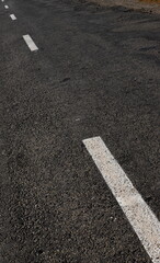 Fototapeta premium White dotted line on city asphalt road background