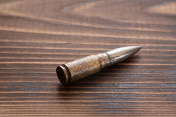 Fototapeta na wymiar Bullet with a sleeve -Carton on a wooden table