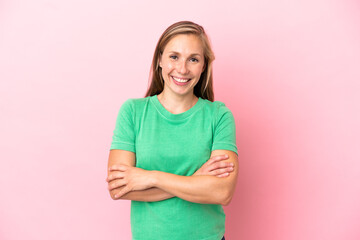 Young English woman isolated on pink background keeping the arms crossed in frontal position
