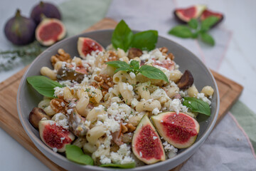 pasta salad with figs and goat cheese on a table