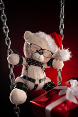 Christmas gift a teddy bear in a Santa Claus hat - an accessory for BDSM games from a sex shop