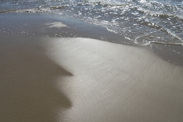 sandy beach and sea foam on the Mediterranean cosat travel destination Spain