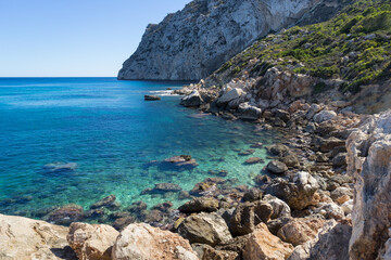 clear turquoise blue water and rocks in a beautiful bay on the Mediterranean coast in Spain
