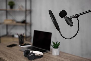 creativity, media content, podcast and blogging concept - workplace with laptop and microphone