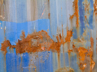 Blue metal shields with irregular rusted areas with copyspace