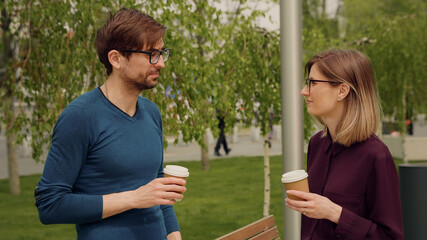 Two colleagues employees discussing planning during break out of office.