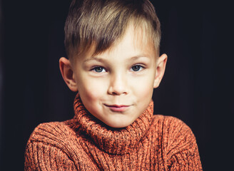 little boy in a knitted sweater close-up