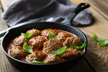 Homemade meatballs in tomato sauce with fresh basil