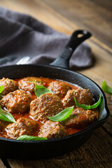 Homemade meatballs in tomato sauce with fresh basil