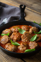 Homemade meatballs in tomato sauce with fresh basil