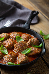 Homemade meatballs in tomato sauce with fresh basil