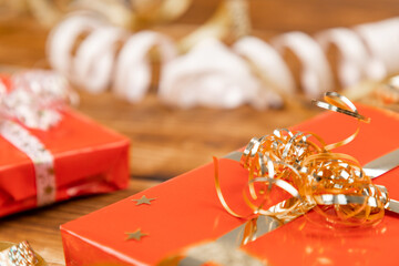 wrapping gifts for christmas on a wooden background