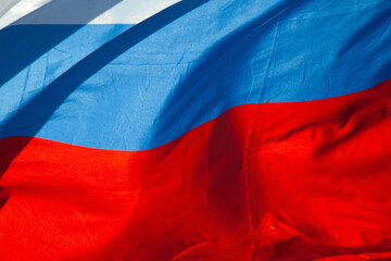 Tricolor flag of Russia waving in the wind close