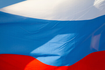 Tricolor flag of Russia waving in the wind close