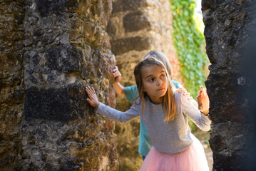 Inquisitive children exploring decaying castle. Curious brother and sister entering old decaying...