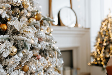 Beautiful Christmas tree with festive gold, white decor against blurred lights on background, closeup. Christmas and New Year concept. 
Background with copyspace, your text space.