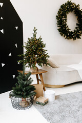 Christmas cozy winter home decor. Christmas decorations of the interior.
Cozy sofa with pillows on the background. The interior of the living room and recreation home decor concepts. 