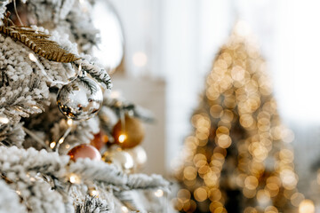 Beautiful Christmas tree with festive gold, white decor against blurred lights on background, closeup. Christmas and New Year concept. 
Background with copyspace, your text space.