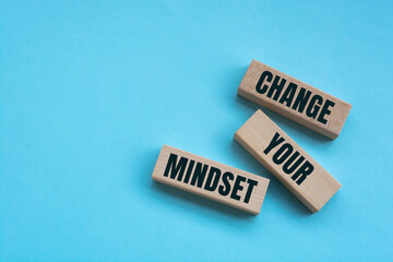 Above are three wooden blocks with the words CHANGE YOUR MINDSET.