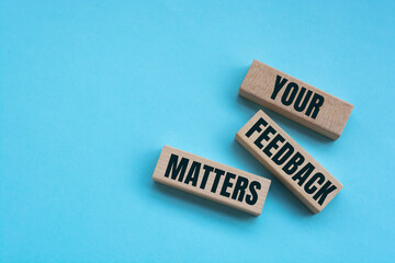 Above are three wooden blocks with the words YOUR FEEDBACK MATTERS