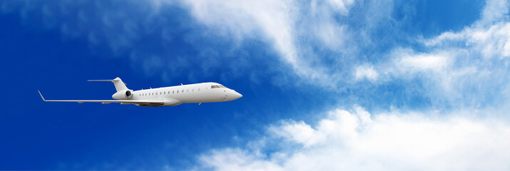 Fototapeta na wymiar Business jet airplane flying on a high altitude above the clouds, panoramic layout