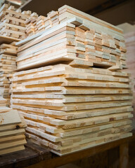 Pine wooden bar blocks materials stacked at carpentry woodwork workshop. Timber wood blanks at diy workbench. Close-up. Handcraft hobby