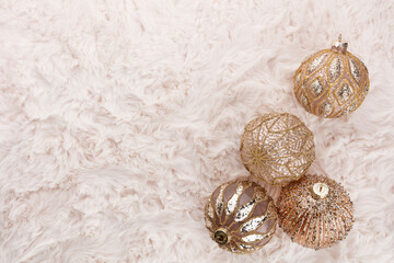 Golden christmas balls with wool background.