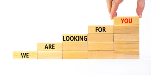 We are looking for you symbol. Wooden blocks with words We are looking for you. Beautiful white background, copy space. Businessman hand. Business, we are looking for you concept.