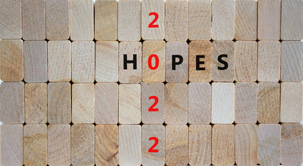 2022 hopes new year symbol. Wooden blocks with words 'Hopes 2022'. Beautiful wooden background, copy space. Business, 2022 hopes new year concept.
