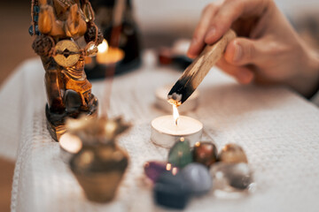 The palasanta incense stick is set on fire near the meditation altar at home.