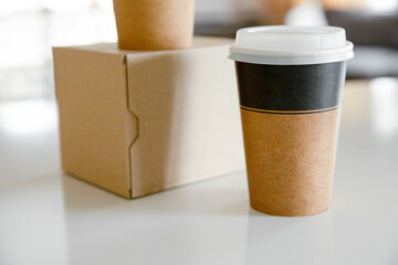 coffee in cardboard brown cups ordered and delivered for takeaway, food delivery, takeout, copy space for text.