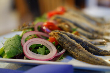 Fried fish with onions and tomato