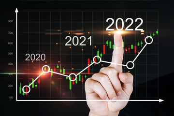 2022. business man hand touching virtual screen graphic graph chart diagram on dark background, investment financial, stock market, trading statistic, business finance, digital technology concept