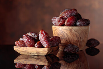 Juicy dates on a black reflective background.