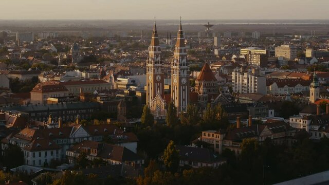 Cinematic aerial view from Votive Church with roofs at daylight in downtown Szeged