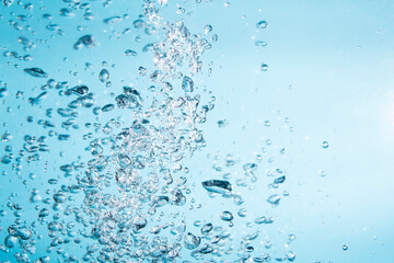 Naklejka na ściany i meble Bubbles of water on blue background