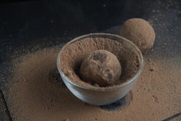 chocolate cake falls flying roll in cocoa powder. Preparation of dessert