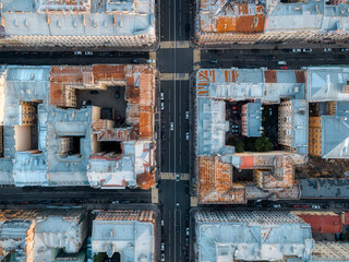 Aerial photo of crossroads of multi-lane roads and rooftops of old residential buildings. Top down view. Courtyards-well of living houses. Saint Petersburg, Russia. Travelling concept.